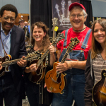 Dick Brown, Tara Linhardt, Tony Williamson, and Jenni Lyn Gardner at the Mandolin Central booth in the exhibit hall at World of Bluegrass 2015 - photo © Tara Linhardt