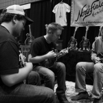 Jake Workman and Adam Steffey jamming in the Northfield booth at World of Bluegrass 2015 - photo © Tara Linhardt