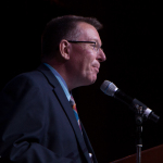 Tom Adams presenting at the Special Awards at the 2016 Wold of Bluegrass - photo © Tara Linhardt