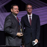 Joe Mullins accepts his Broadcaster of the Year Award from Chris Jones at the 2016 Wold of Bluegrass - photo © Tara Linhardt