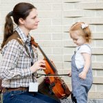 Sampling a fiddle at World of Bluegrass 2014 (10/2/14) - photo by Todd Powers