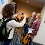 Irene Kelly snaps a pic of Louisa Branscomb and Claire Lynch at 2014 Wide Open Bluegrass - photo by Todd Powers