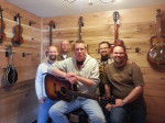 Staff at the Acoustic Shoppe, pose with their first guitar purchaser: Jeremy Chapman, Gene Hoke, Eric, Jason Chapman, John Chapman