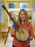 Annmarie Reiley-Kay, curator of the Earl Scruggs Center, with a banjo that had belonged to SCruggs's grandfather