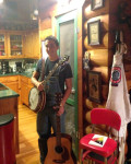 Luke Munday at home with his returned banjo and guitar