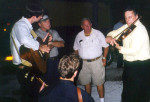 Myron Dillman (center) watching Jim Moss play the fiddle in a late night jam at Bean Blossom 2001 - photo by Lisa Riha