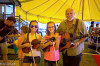 John Hoffman with a pair of young fiddlers in the tent at Galax 2014 - photo by Tara Linhardt
