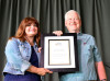 Cindy Baucom presents IBMA certificate to Norman Adams - photo by Deb Miller
