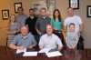 Snyder Family signs with Mountain Home (standing) Samantha Snyder, Van Atkins, Ty Gilpin, Zeb Snyder, Laine Snyder, Tim Surrett, Owen Snyder. (seated) Mickey Gamble, Bud Snyder