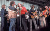 Doyle Lawson shares a mic with Eddie Adcock at a stage jam in the 1970s along with J.D. Crowe, Ralph Stanley, Keith Whitley, Peter Rowan, Tony Rice and Charlie Waller - photo by Fred Robbins