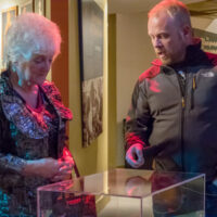 Jamie Dailey explains an item to Carolyn Vincent at the Dailey & Vincent exhibit at the International Bluegrass Music Museum in Owensboro, KY - photo by Ryan Hobson