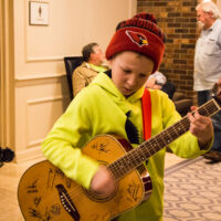 10 year old Donovan jams in the hallways at the 2017 Joe Val Bluegrass Festival - photo © Tara Linhardt