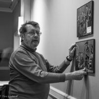 Darwin Davidson hanging photos preparing for the 2017 Joe Val Bluegrass Festival - photo © Tara Linhardt