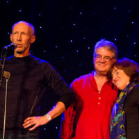 Jeff Horton, Janet Kropp, and Taylor Armeding receive BBU Heritage Award for the late Mike Kropp at Joe Val Bluegrass Festival (2/18/17) - photo © Tara Linhardt