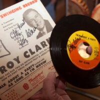 Roy Clark with a signed poster and 45 RPM single at the American Banjo Museum