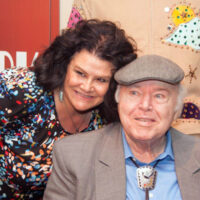 Roy Clark poses with interviewer Pam Tucker at the American Banjo Museum