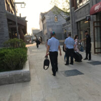 Chinese security guards assist the Mountain Music Ambassadors getting their instruments to the stage