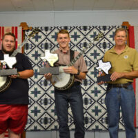 Brady Gandy, Hudsen Docuette, and Eric Welty, top finishers in the Texas Banjo Championship for 2017 with their trophies - photo by Tina Boatwright
