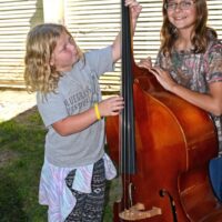 Kids get some hands on time with bluegrass instruments at the 2017 Marshall Bluegrass Festival - photo © Bill Warren