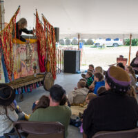 Kids mesmerized by puppet show at the 2017 Oldtone Roots Music Festival - photo © Tara Linhardt