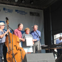 Senators Tim Kaine and Lamar Alexander present Leah Ross with a copy of the original score for Tennessee Waltz at the 2017 Rhythm & Roots Reunion - photo by Teresa Gereaux