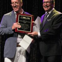 Fletcher Bright's son and Bill Evans accepting Fletcher's 2017 Distinguished Achievement Award from the IBMA - photo by Frank Baker