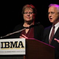 Nancy Cardwell and Fred Bartenstein speak about the Foundation for Bluegras Music at the 2017 IBMA Special Awards luncheon - photo by Frank Baker