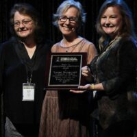 Dale Ann Bradley, Louisa Branscomb, and Jeanette Williams accepting Louisa's 2017 Distinguished Achievement Award from the IBMA - photo by Frank Baker