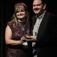 Cindy Baucom and Joe Mullins accepting the 2017 Broadcaster of the Year Award from the IBMA - photo by Frank Baker