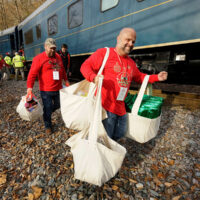 Volunteers hauling out the loot from the Santa Train - photo by Ed Rode (2018)