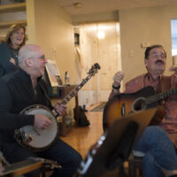 Mary Burdette, Terry Wittenberg (banjo), Bob Perilla (guitar) at the Bob Perilla Book Reveal at Akira Otsuka's New Year's 2018 party - photo by Steve Barrett