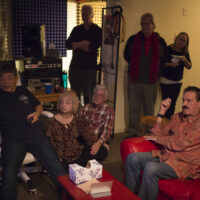 Akira Otsuka, Barb Diederich, Mike Munford, Chris Stifel, Esther Haynes and Bob Perilla in Akira’s basement studio previewing footage from the upcoming Bluegrass 45 movie at the Bob Perilla Book Reveal at Akira Otsuka's New Year's 2018 party - photo by Jeromie Stephens