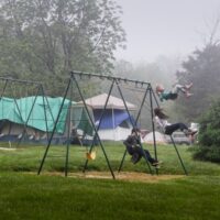 Swinging in the rain at the May 2018 Gettysburg Bluegrass Festival - photo by Frank Baker