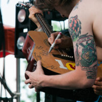 Billy Strings signs a guitar at Rooster Walk 2018 - photo © Gina Elliott Proulx