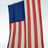 American flag hangs from a crane at the 2018 Norwalk Music Festival - photo © Bill Warren