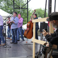 MC Dennis Jones snaps a pic of Sideline at Red, White & Bluegrass 2018 - photo by Laura Tate Photography