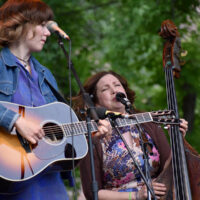 Molly Tuttle and Missy Raines with First Ladies of Bluegrass at RockyGrass 2018 - photo by Kevin Slick