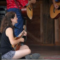 Tara Linhardt coaches her charges at the Kid's Academy at the August 2018 Gettysburg Bluegrass Festival - photo by Frank Baker
