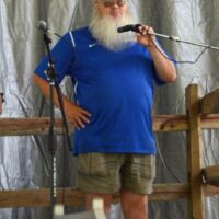 Russ Quinton welcomes the crowd at the 2018 Blissfield Bluegrass on the River - photo © Bill Warren