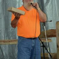 Bill Luzier auctions pies at the 2018 Blissfield Bluegrass on the River - photo © Bill Warren