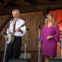 Terry and Cindy Baucom with The Dukes of Drive at the August 2018 Gettysburg Bluegrass Festival - photo by Frank Baker