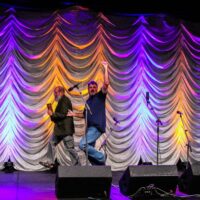 Vince Gill races George Gruhn around the stage at the 2018 IBMA Special Awards - photo © Frank Baker