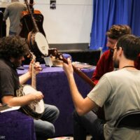 Gabe Hirschfeld, Wes Corbett, and Bennett Sullivan try out banjos at the 2018 Wold of Bluegrass (9/26/18) - photo by Frank Baker