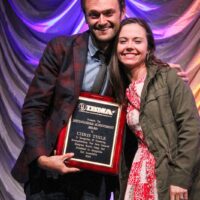 Chris Thile with Sierra Hull and his Distinguished Achievement Award at the 2018 IBMA Special Awards - photo © Frank Baker