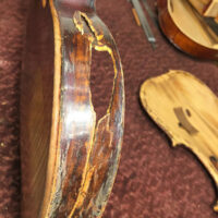 Major damage to the side of the Scotty Stoneman fiddle - photo by RJ Storm