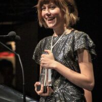 Molly Tuttle accepts Guitar Player of the Year at the 2018 International Bluegrass Music Awards - photo © Frank Baker