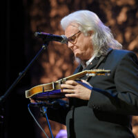 Ricky Skaggs examines Bill Monroe's mandolin after he is inducted into the Country Music Hall of Fame (10/21/18) - photo by Jason Kempin/Getty Images