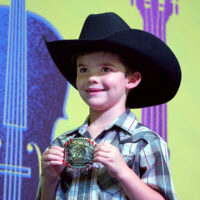 Trustin Paskvan with his buckle at the 2018 Oklahoma State Picking and Fiddling Championship - photo by Pamm Tucker