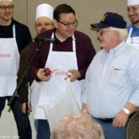 Pastor Joe delivers a bag of turnips, and a nice donation, during the fundraising breakfast at the November 2018 SOIMF - photo © Bill Warren