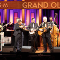 Del McCoury Band on the Grand Ole Opry presents Del McCoury with a 15th Anniversary print (11/3/18) - photo by Chris Hollo